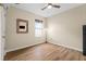 Cozy bedroom with light walls, wood floors, and a ceiling fan at 35107 Sweet Leaf Ln, Leesburg, FL 34788