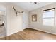 Comfortable bedroom with wood floors, neutral walls, and a mounted steer skull decoration at 35107 Sweet Leaf Ln, Leesburg, FL 34788