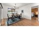 Inviting dining room with a wooden table, bench seating, and modern chandelier at 35107 Sweet Leaf Ln, Leesburg, FL 34788