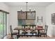 Dining area features a wooden table and a stylish chandelier at 35107 Sweet Leaf Ln, Leesburg, FL 34788