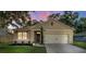 Charming single-story home with a well-manicured lawn and a two-car garage at 35107 Sweet Leaf Ln, Leesburg, FL 34788