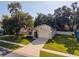 Inviting single-story home with a well-maintained lawn, driveway, and mature trees at 35107 Sweet Leaf Ln, Leesburg, FL 34788
