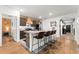 Charming kitchen features an island with seating and dark cabinetry at 35107 Sweet Leaf Ln, Leesburg, FL 34788