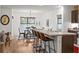 Bright kitchen with a large island and seating, open to the dining area with modern lighting at 35107 Sweet Leaf Ln, Leesburg, FL 34788