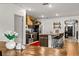 Well-lit kitchen with a view of the dining room and living room, featuring a kitchen island at 35107 Sweet Leaf Ln, Leesburg, FL 34788