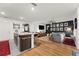 Open-concept living room with a kitchen island, hardwood floors, and a comfortable seating area at 35107 Sweet Leaf Ln, Leesburg, FL 34788