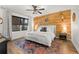 Cozy bedroom with a wooden accent wall, neutral tones, and a window with natural light at 35107 Sweet Leaf Ln, Leesburg, FL 34788