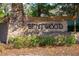 Stone entrance sign for Bentwood, surrounded by lush greenery, welcoming residents and visitors at 35107 Sweet Leaf Ln, Leesburg, FL 34788