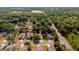 Residential neighborhood view of homes surrounded by mature trees and green lawns, offering a serene living environment at 35107 Sweet Leaf Ln, Leesburg, FL 34788
