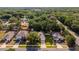 Charming suburban home with a lush green lawn, mature trees, and neighboring residences in a peaceful community at 35107 Sweet Leaf Ln, Leesburg, FL 34788