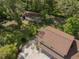 Aerial view of a brown roof house and detached garage with a basketball hoop and long driveway at 35350 County Road 439, Eustis, FL 32726