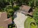 Aerial view of a brown roof house, detached garage, long driveway and landscaped yard with pond at 35350 County Road 439, Eustis, FL 32726