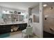 A well-lit bathroom with a double sink vanity, a large mirror, and a frosted glass walk-in shower at 35350 County Road 439, Eustis, FL 32726