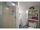 Cozy bathroom featuring a shower, vanity, and shelving for storage and décor at 35350 County Road 439, Eustis, FL 32726