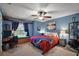 Cozy bedroom with a window seat, ceiling fan, and a calming blue color scheme at 35350 County Road 439, Eustis, FL 32726