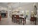 Formal dining room area featuring a fireplace, french doors, and elegant chandelier over the wood dining table at 35350 County Road 439, Eustis, FL 32726