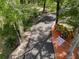 Long tree lined driveway with a 'Welcome To Our Happy Place' flag attached to a tree trunk at 35350 County Road 439, Eustis, FL 32726