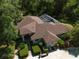 Exterior view of a house with a brown roof, manicured landscaping, bench, and circular driveway at 35350 County Road 439, Eustis, FL 32726