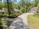 Inviting single-story home featuring mature landscaping and a long driveway, offering privacy and curb appeal at 35350 County Road 439, Eustis, FL 32726