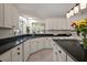Bright eat-in kitchen featuring modern white cabinetry, a large window, and modern appliances at 35350 County Road 439, Eustis, FL 32726
