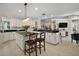A generous eat-in kitchen with large center island offering seating, and a view into the living area at 35350 County Road 439, Eustis, FL 32726