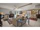 Cozy living room featuring neutral sofas, a piano, and a charming mix of decor and furnishings at 35350 County Road 439, Eustis, FL 32726
