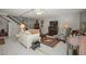 Cozy living room with a fireplace, comfortable seating, piano, and staircase at 35350 County Road 439, Eustis, FL 32726