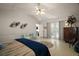 A spacious main bedroom with en suite bathroom featuring wood flooring, accent furniture and neutral decor at 35350 County Road 439, Eustis, FL 32726