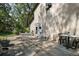 A concrete patio features multiple seating areas, potted plants, and shade from surrounding trees at 35350 County Road 439, Eustis, FL 32726
