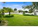 Expansive backyard featuring lush green grass, privacy fence, and tropical landscaping at 356 Giovani Blvd, Clermont, FL 34715