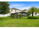 Expansive backyard featuring lush green grass, swimming pool, and tropical landscaping at 356 Giovani Blvd, Clermont, FL 34715