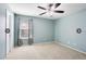 This empty bedroom features a ceiling fan, neutral carpet and light blue walls at 356 Giovani Blvd, Clermont, FL 34715