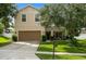 Two-story home featuring a two-car garage and a well-manicured lawn at 356 Giovani Blvd, Clermont, FL 34715
