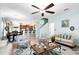 Open-concept living area with modern decor, including an elegant ceiling fan and stylish furniture at 356 Giovani Blvd, Clermont, FL 34715