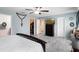 This is another view of the main bedroom with a ceiling fan, grey wood floors and an ensuite bathroom at 356 Giovani Blvd, Clermont, FL 34715