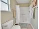 Bright bathroom featuring a shower with white tile, and modern fixtures at 3590 Auburndale Ave, The Villages, FL 32162