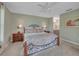 Cozy bedroom features decorative bed frame, soft carpet, and neutral wall color at 3590 Auburndale Ave, The Villages, FL 32162