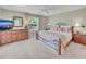 Serene bedroom with natural light, decorative bed frame, dresser, and soft carpet at 3590 Auburndale Ave, The Villages, FL 32162