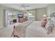 Bright bedroom features a sliding door to the patio, and scenic backyard view at 3590 Auburndale Ave, The Villages, FL 32162