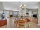 Open-concept dining area boasts a decorative chandelier, flowing into the living room and kitchen for easy entertaining at 3590 Auburndale Ave, The Villages, FL 32162