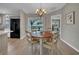 Dining area with wood table and views to the outside, adjacent to the kitchen, featuring hardwood floors at 3590 Auburndale Ave, The Villages, FL 32162