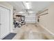 Spacious garage with ample storage space, a golf cart and a well-maintained concrete floor at 3590 Auburndale Ave, The Villages, FL 32162