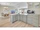 Well-lit kitchen with light-pink countertops offers seamless transition to the dining area and living space at 3590 Auburndale Ave, The Villages, FL 32162