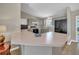 Kitchen features light-pink countertops with ample space, gray cabinets, and modern appliances at 3590 Auburndale Ave, The Villages, FL 32162