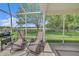 Spacious screened lanai perfect for outdoor living and entertaining with a view of the backyard at 3590 Auburndale Ave, The Villages, FL 32162