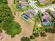 A high angle view displays the home with screened pool, landscaping, and large yard at 3733 Statham Dr, Apopka, FL 32712