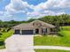 Expansive aerial view of a well-maintained property with lush landscaping, a spacious driveway, and a fenced backyard at 3733 Statham Dr, Apopka, FL 32712