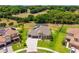 Panoramic aerial view showcasing the property's spacious yard, bordered by trees, and screened-in pool at 3733 Statham Dr, Apopka, FL 32712