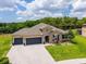 An elevated view showcases this single-story home, surrounded by lush greenery and well-manicured landscaping at 3733 Statham Dr, Apopka, FL 32712