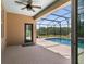 A covered patio looks onto a screened pool area with nice landscaping and backyard at 3733 Statham Dr, Apopka, FL 32712
